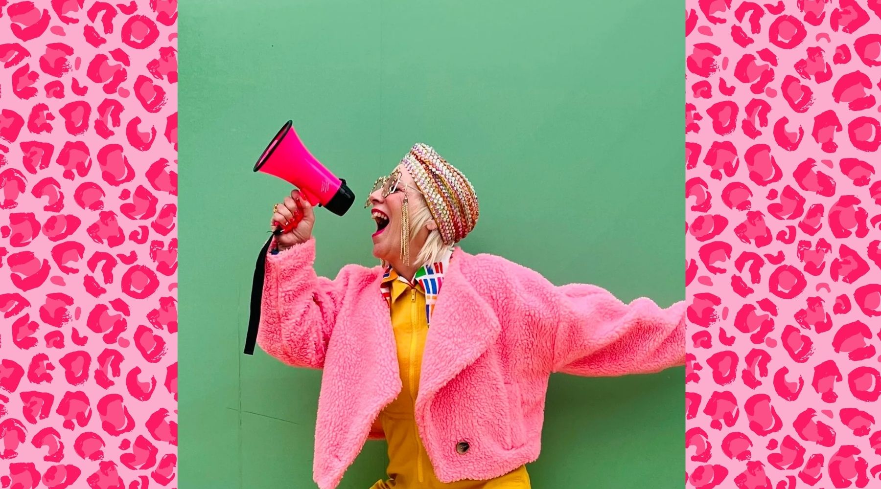 Photo of a woman wearing a bright pink jacket and holding a pink megaphone in front of a green background. The photo is laid over a pink leopard print graphic background.