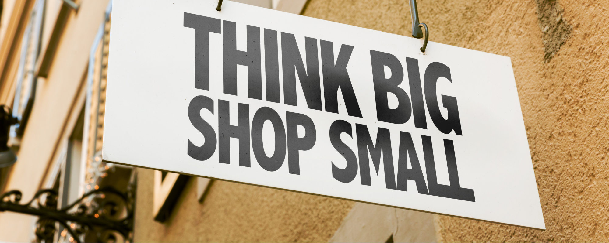 A shop sign that reads 'Think Big, Shop Small'